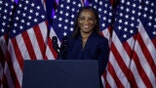 Laphonza Butler in front of American flags