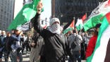 Demonstrators attend an “emergency rally for Gaza” outside of the Israeli Consulate