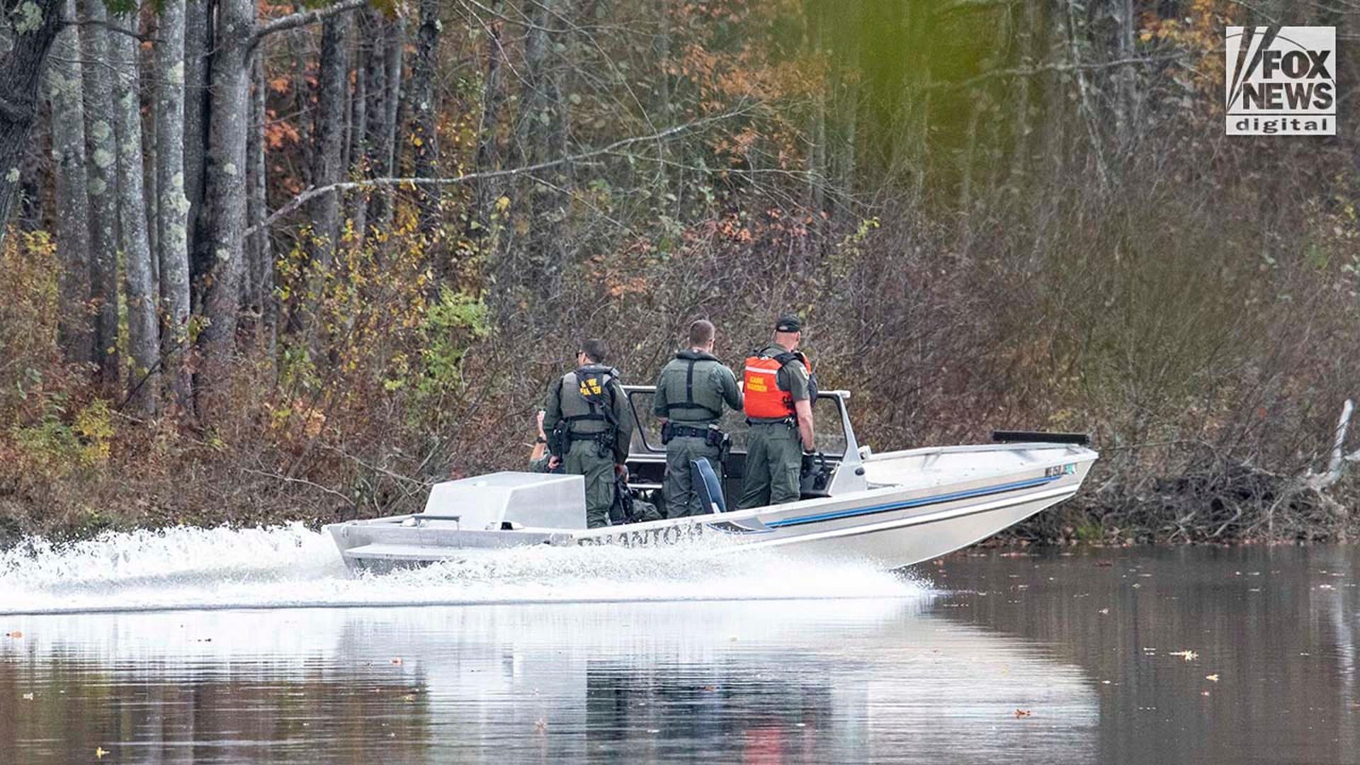 Law enforcement agents aid in the search for Robert Card along the Androscoggin River