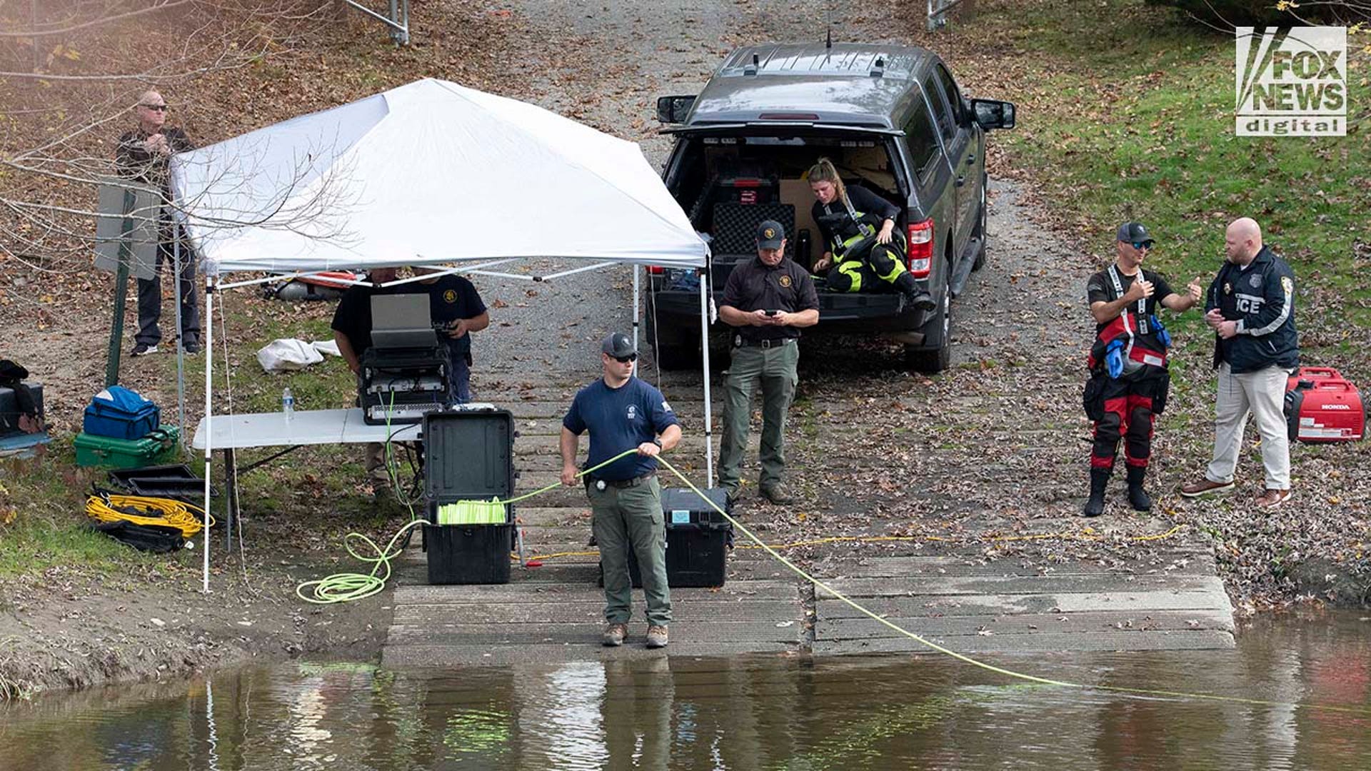 Law enforcement agents aid in the search for Robert Card along the Androscoggin River