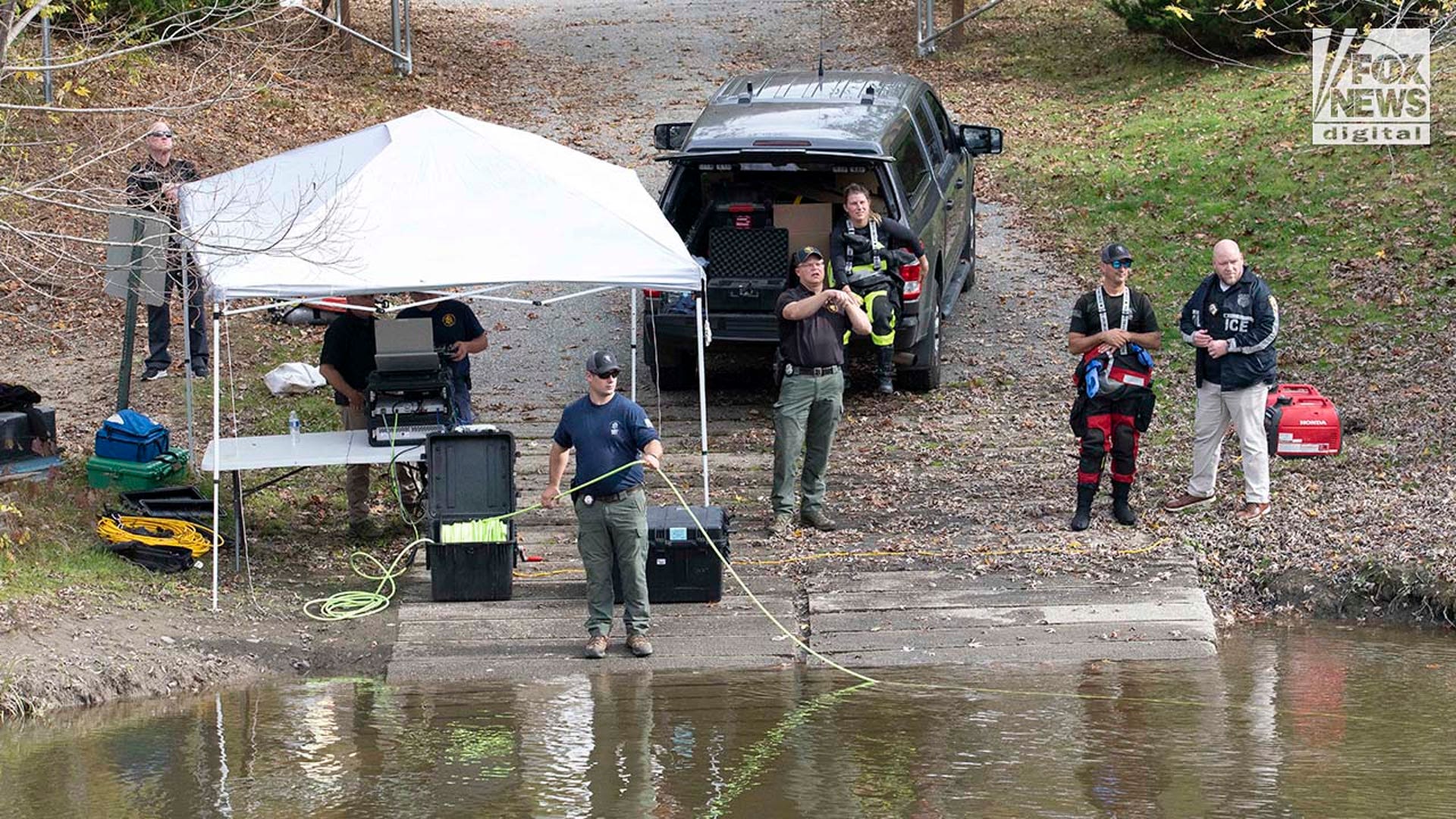 Law enforcement agents aid in the search for Robert Card along the Androscoggin River
