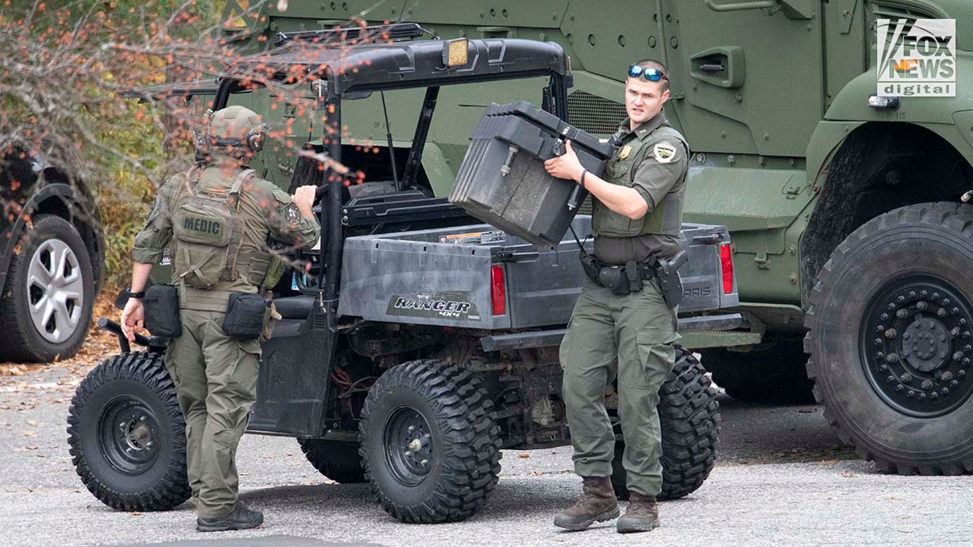 Law enforcement agents aid in the search for Robert Card along the Androscoggin River