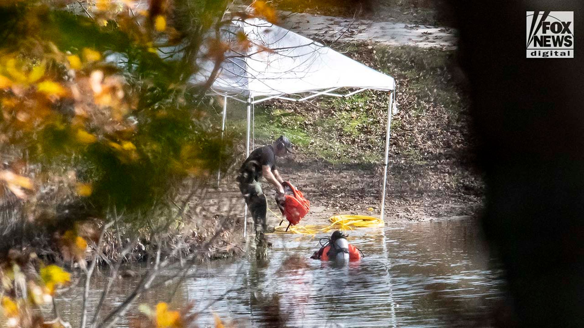 Law enforcement agents aid in the search for Robert Card along the Androscoggin River