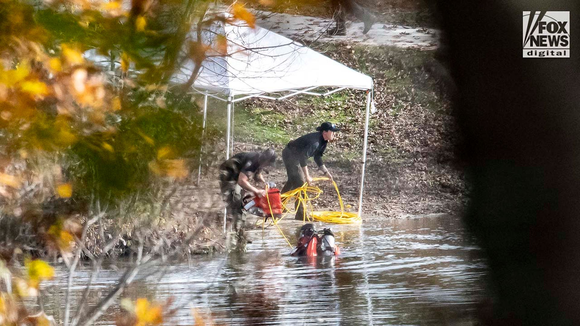 Law enforcement agents aid in the search for Robert Card along the Androscoggin River