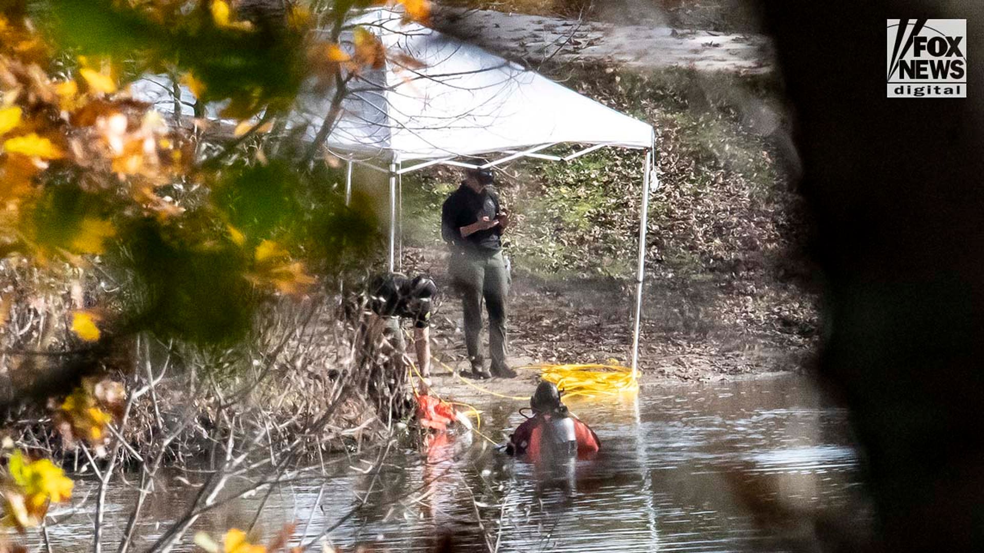 Law enforcement agents aid in the search for Robert Card along the Androscoggin River