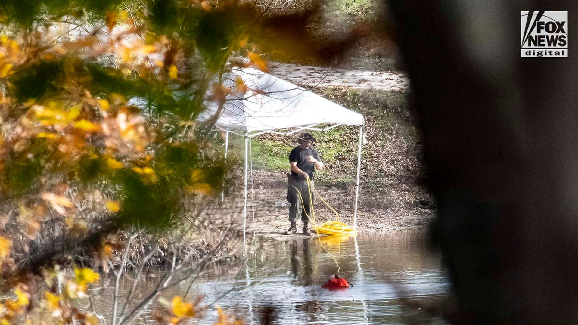 Law enforcement agents aid in the search for Robert Card along the Androscoggin River