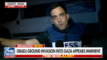 FOX News' Trey Yingst takes cover from Hamas rocket attack during live report