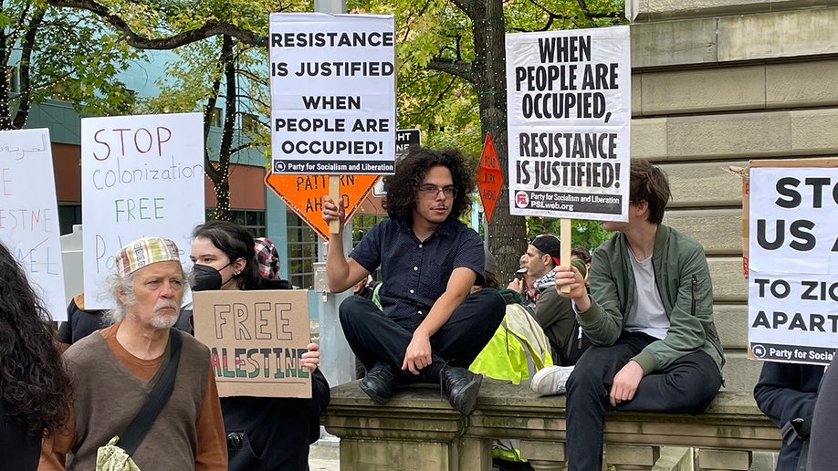 Crowd of pro-Palestinian demonstrators with signs outside Portland City Hall