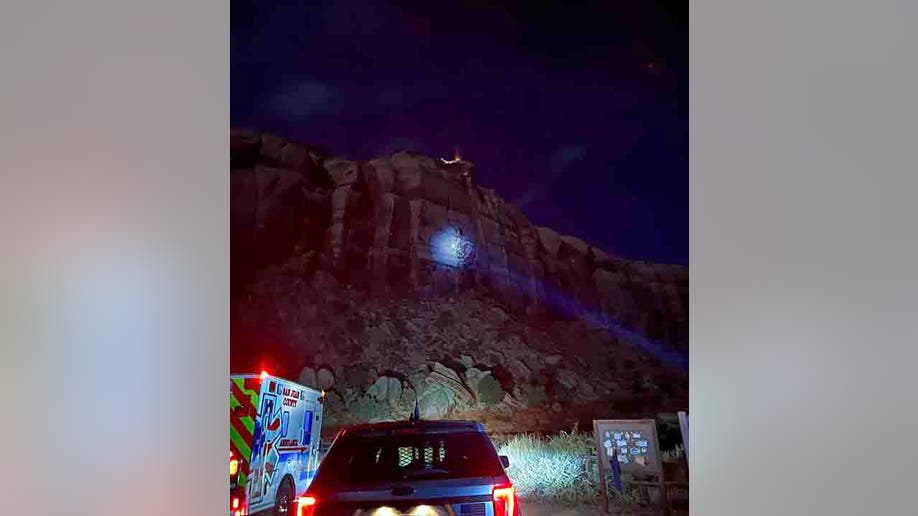 rescuers shining a light on the cliff face