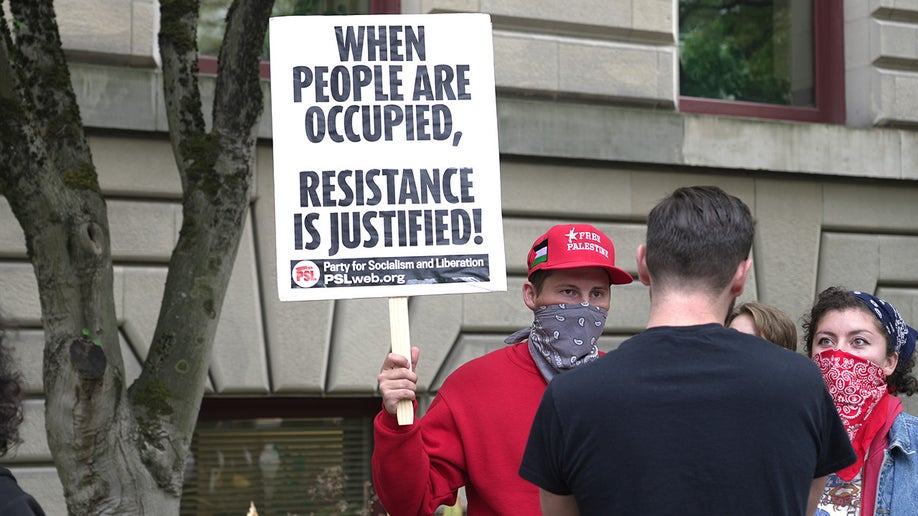 Pro-Palestinian protester holding a sign in Portland