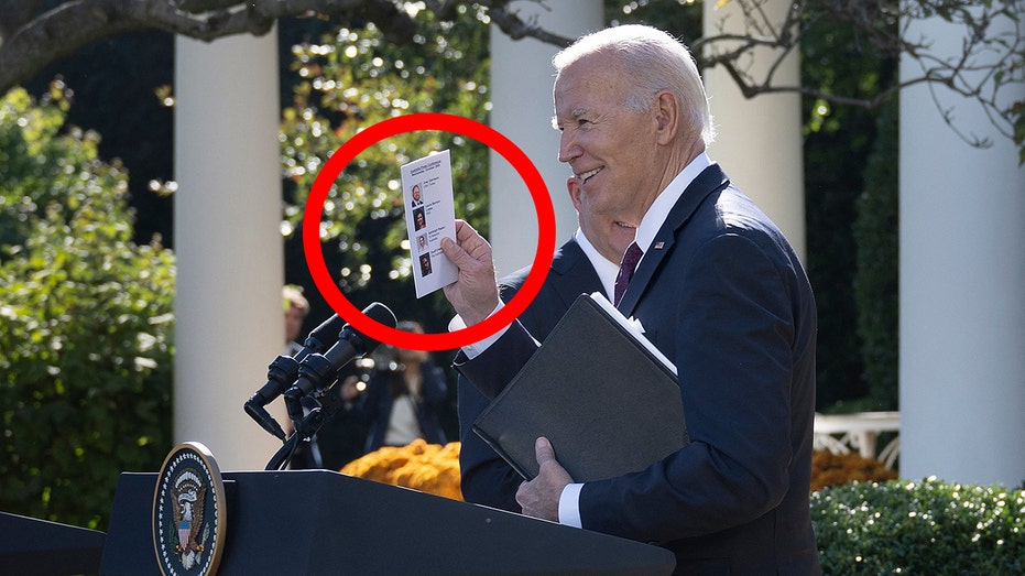 Biden spotted holding a note card with reporters' photos and names to call on at joint presser