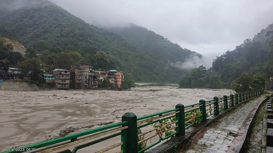 Heavy rainfall triggers sudden flooding in northeastern India, resulting in fatalities and submerging towns