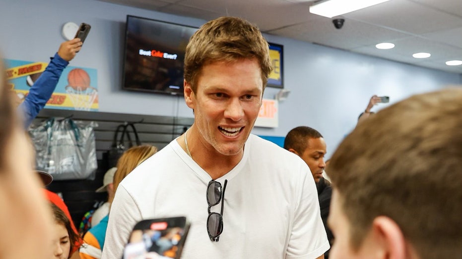 Tom Brady Makes Surprise Visit to Trading Card Store with Kevin