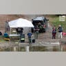Law enforcement agents aid in the search for Robert Card along the Androscoggin River