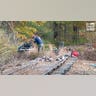 Law enforcement agents aid in the search for Robert Card along nearby railroad tracks by the Androscoggin River