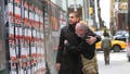 Michael Levy (left, in dark coat) and Thomas Hand (right) comfort each other in front of kidnapped-by-Hamas posters in New York City, Wednesday, November 15, 2023. Hand, whose 8-year-old daughter is being held hostage confronted a woman tearing down such posters  recently in Manhattan.