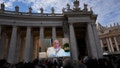 Pope Francis appears on a giant monitor set up in St. Peter's Square at The Vatican, Sunday, Nov. 26, 2023, as he blesses the faithful gathered in the square for the traditional Angelus noon prayer.