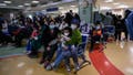 TOPSHOT - Children and their parents wait at an outpatient area at a children hospital in Beijing on November 23, 2023. The World Health Organization has asked on November 23, 2023, China for more data on a respiratory illness spreading in the north of the country, urging people to take steps to reduce the risk of infection. China has reported an increase in "influenza-like illness" since mid-October when compared to the same period in the previous three years, the WHO said. (Photo by Jade Gao / AFP) (Photo by JADE GAO/AFP via Getty Images)