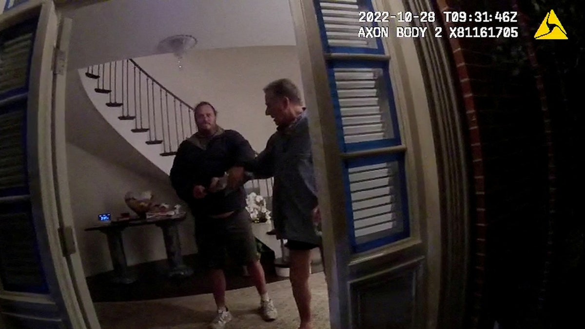 A screenshot from a police body camera video shows David DePape, left, holding onto Paul Pelosi, the husband of then-House Speaker Nancy Pelosi, in the couple’s house on Oct. 28, 2022. 