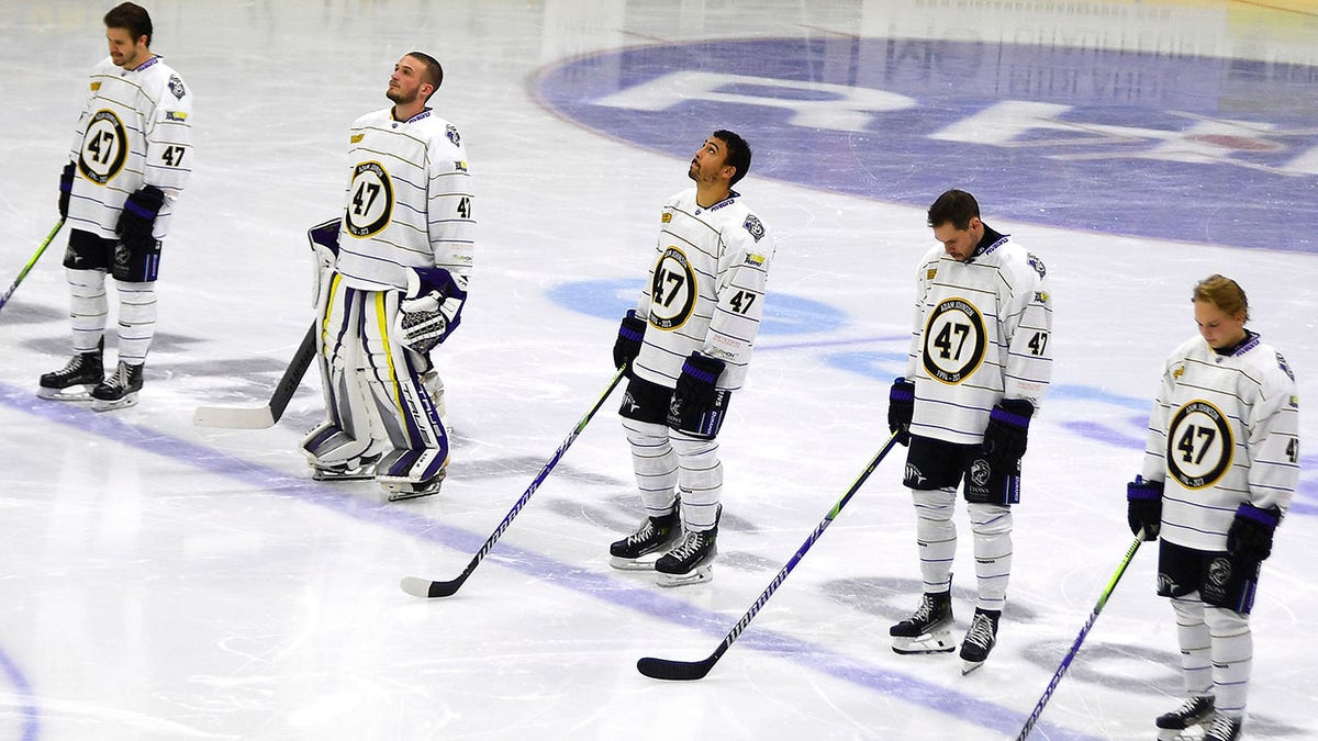 Players honoring Adam Johnson