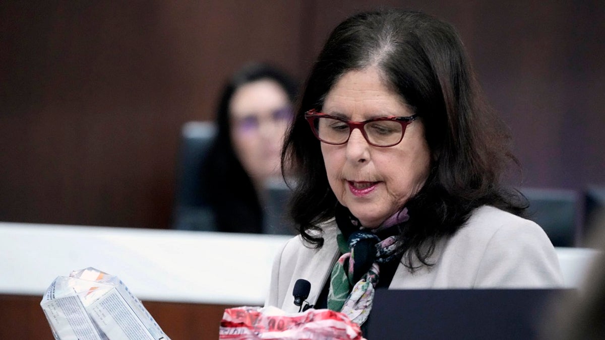 Defense attorney Donna Jean Kuchler holds evidence while making her case in court