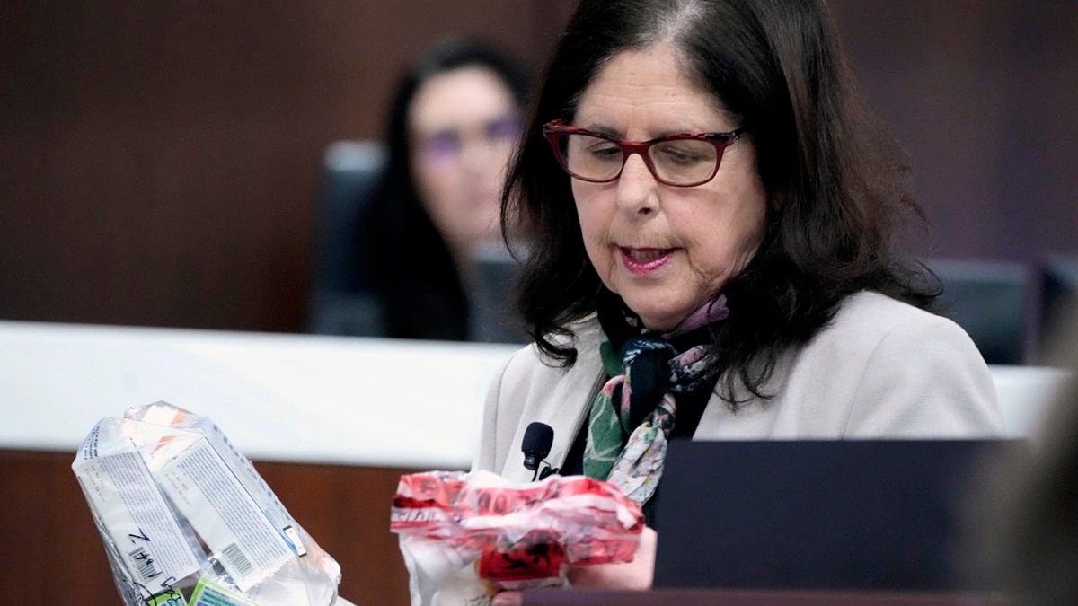 Defense attorney Donna Jean Kuchler holds evidence while making her case in court