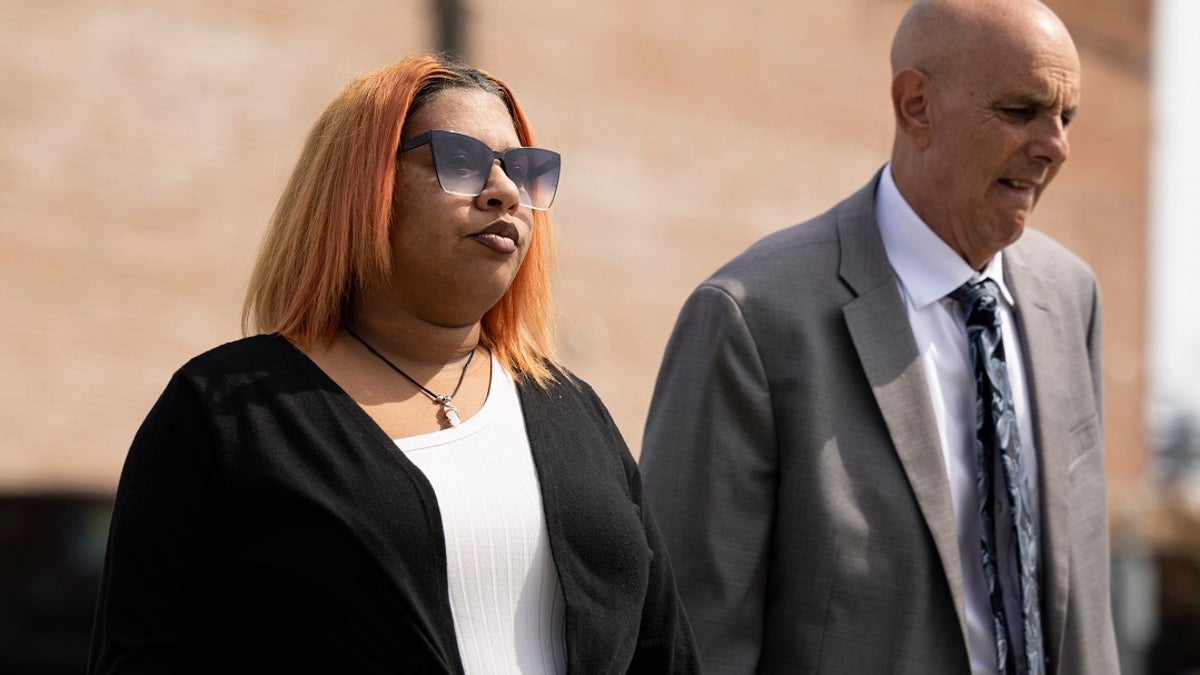 Deja Taylor arrives to the federal court building in Virginia with her lawyer