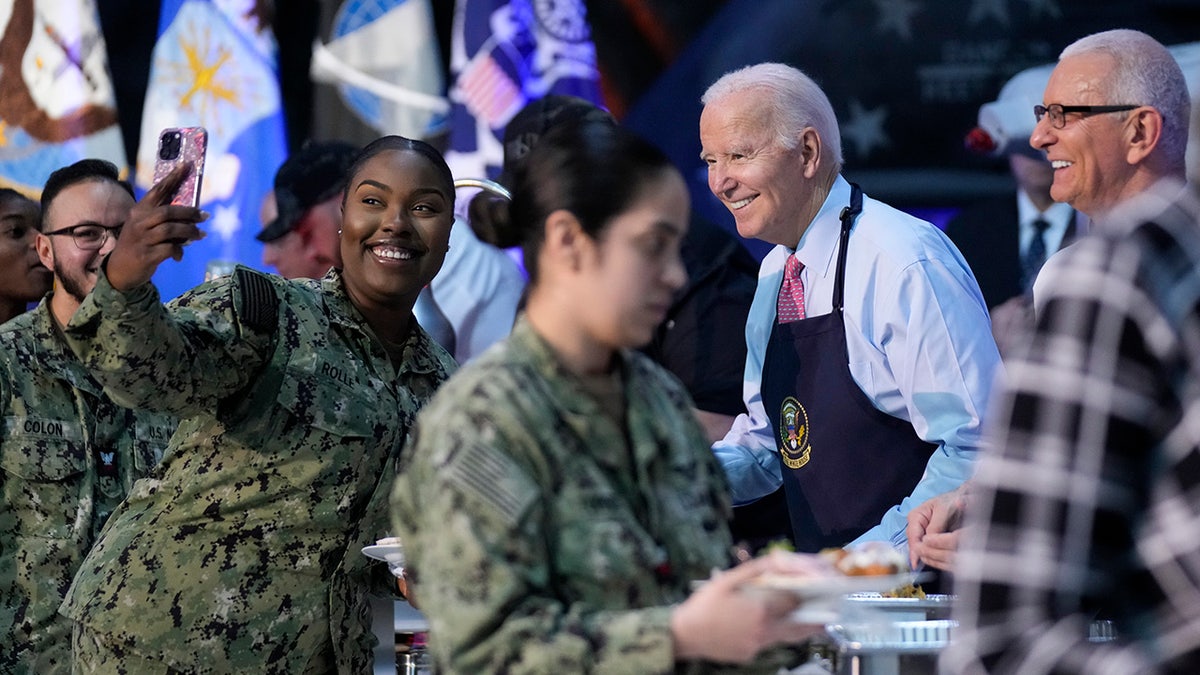 Biden smiles for selfie while serving Friendsgiving meal
