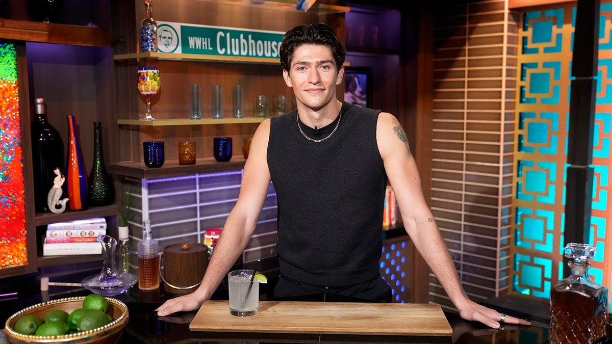 Barton Cowperthwaite posing behind a bar