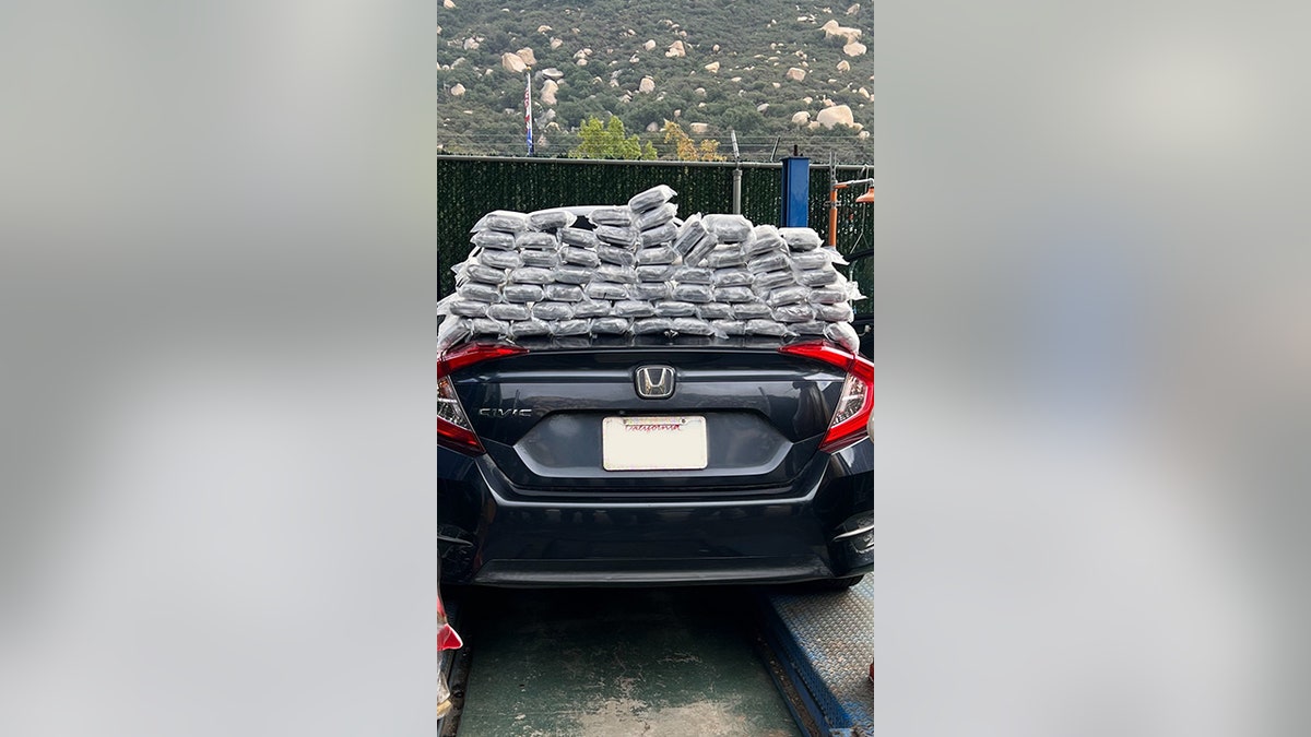 bundles of fentanyl pills stacked on truck of car