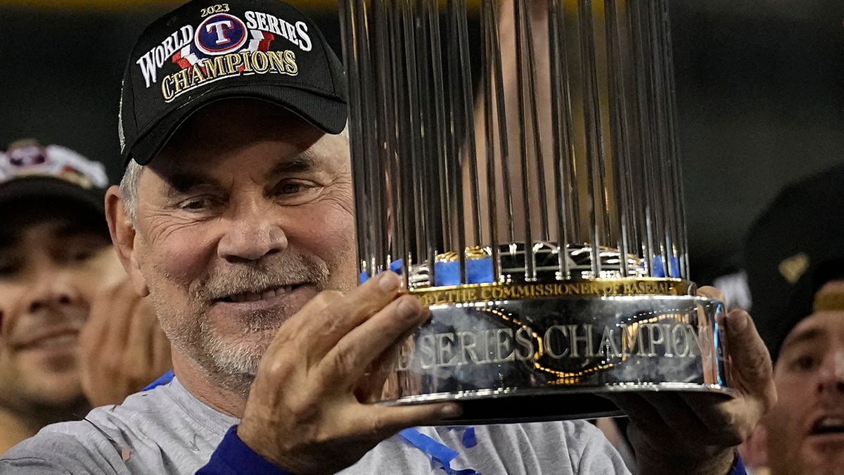 Bruce Bochy holds the World Series trophy