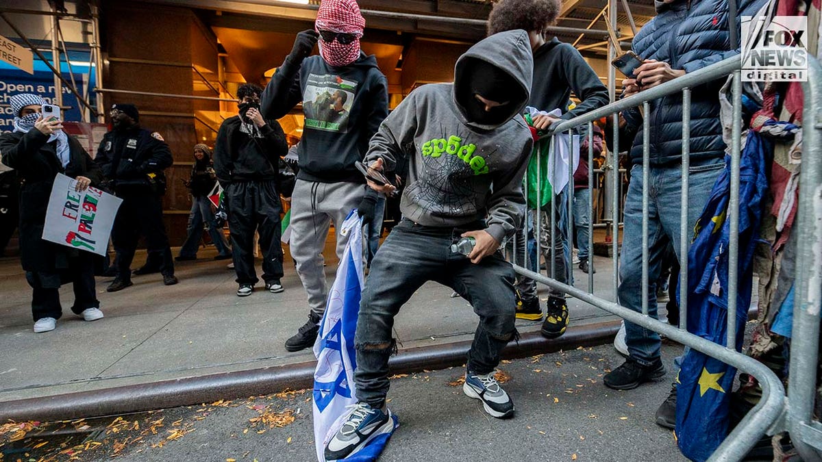 Protester is seen stomping on Israeli flag