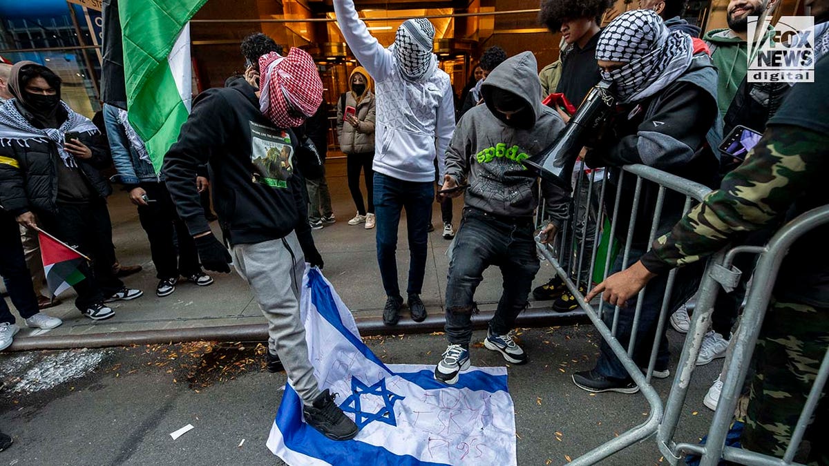 Protester is seen stomping on Israeli flag