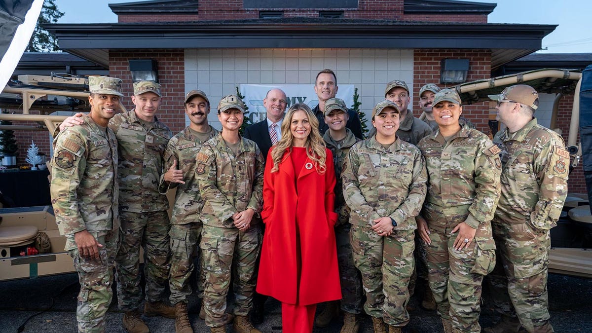 Candace Cameron Bure posing with members of the military