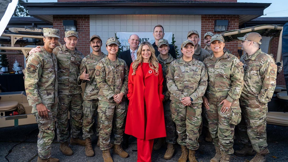 Candace Cameron Bure posing with members of the military