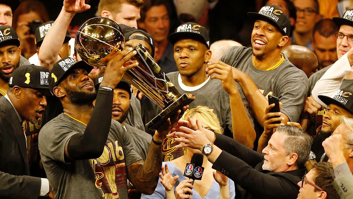 LeBron James hoists the Larry O'Brien trophy