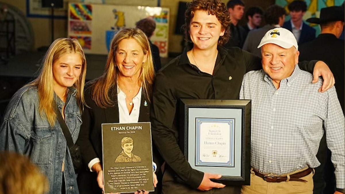Chapin Family holds plaque at Sigma Chi dinner