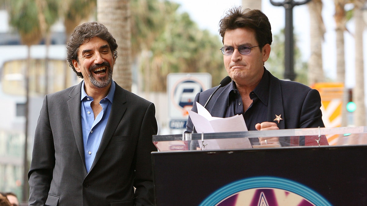 Chuck Lorre and Charlie Sheen at a ceremony
