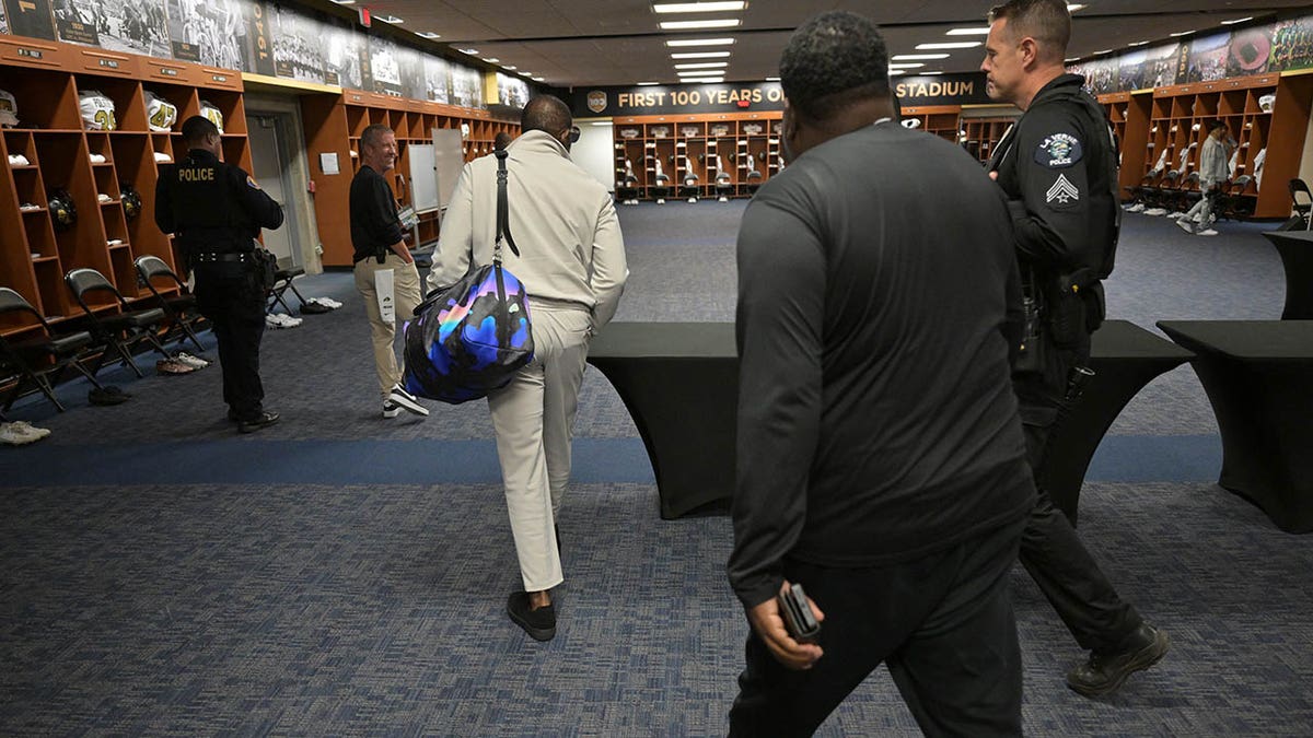 Deion Sanders walks through the Colorado Buffaloes locker room at Rose Bowl Stadium