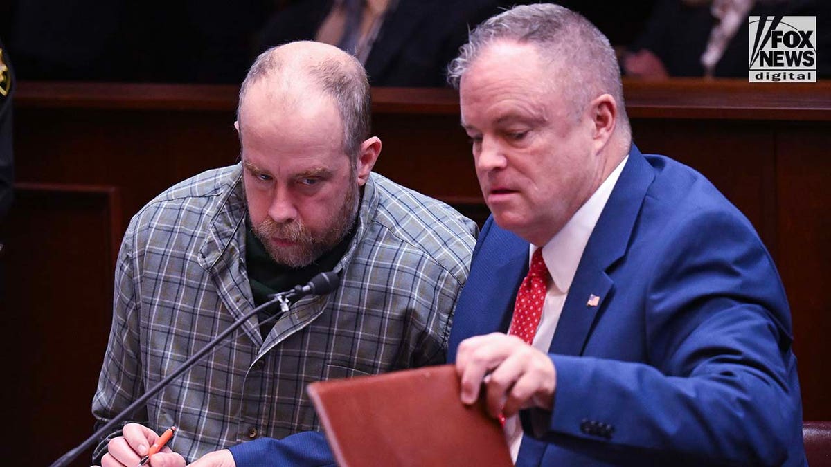 Craig Nelson Ross Jr. sits alongside his conflict attorney George Conway for his arraignment