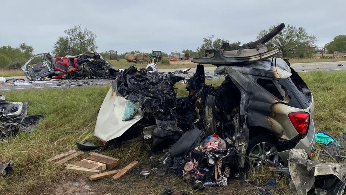 Image of two vehicles burnt and destroyed on the side of a Texas road