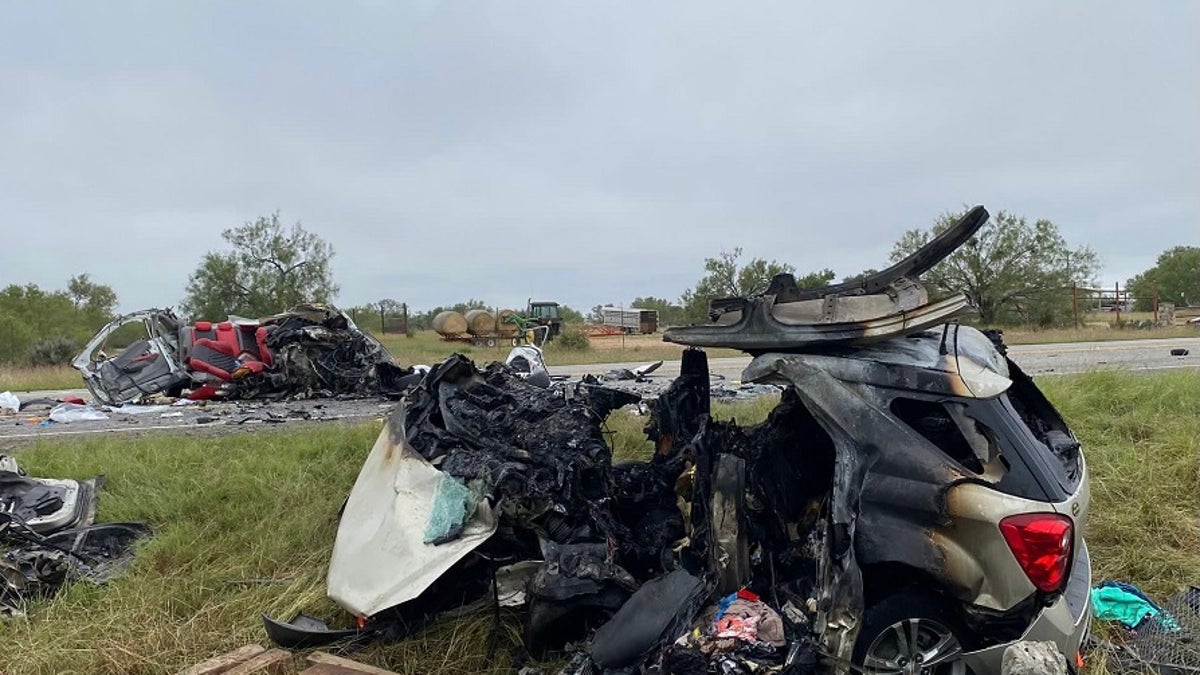 Image of two vehicles burnt and destroyed on the side of a Texas road