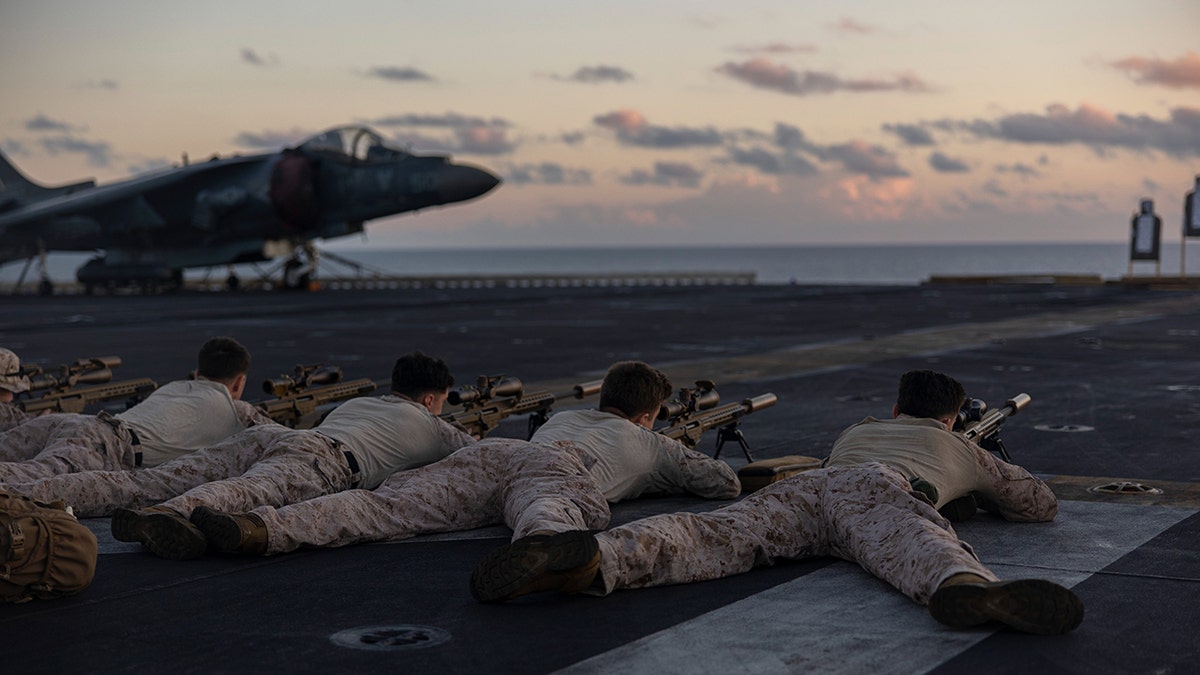 Military personnel on a carrier