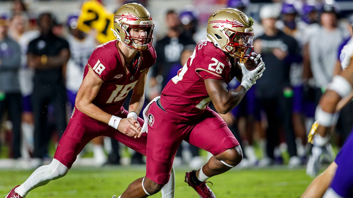 Florida State's Tate Rodemaker hands the ball off