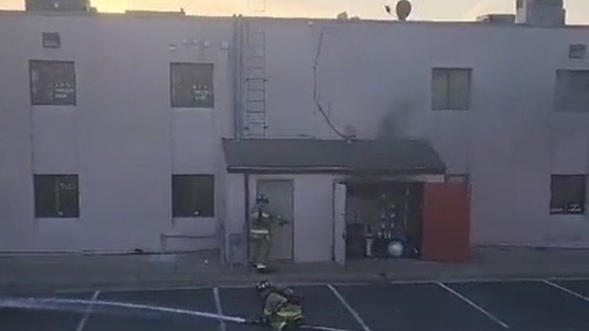 Unidentified firefighter pries open door