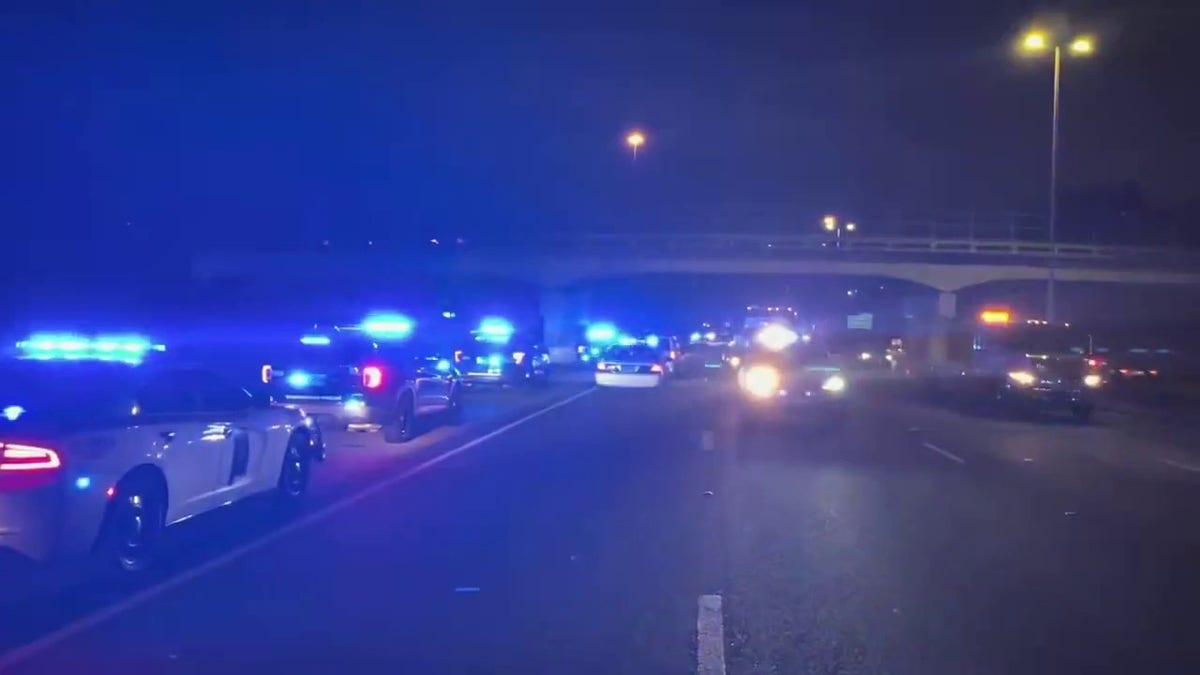 Police cruisers with lights on interstate