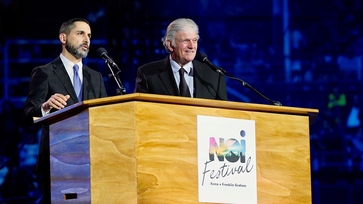 Billy Graham and man at podium saying "Noi Festival"