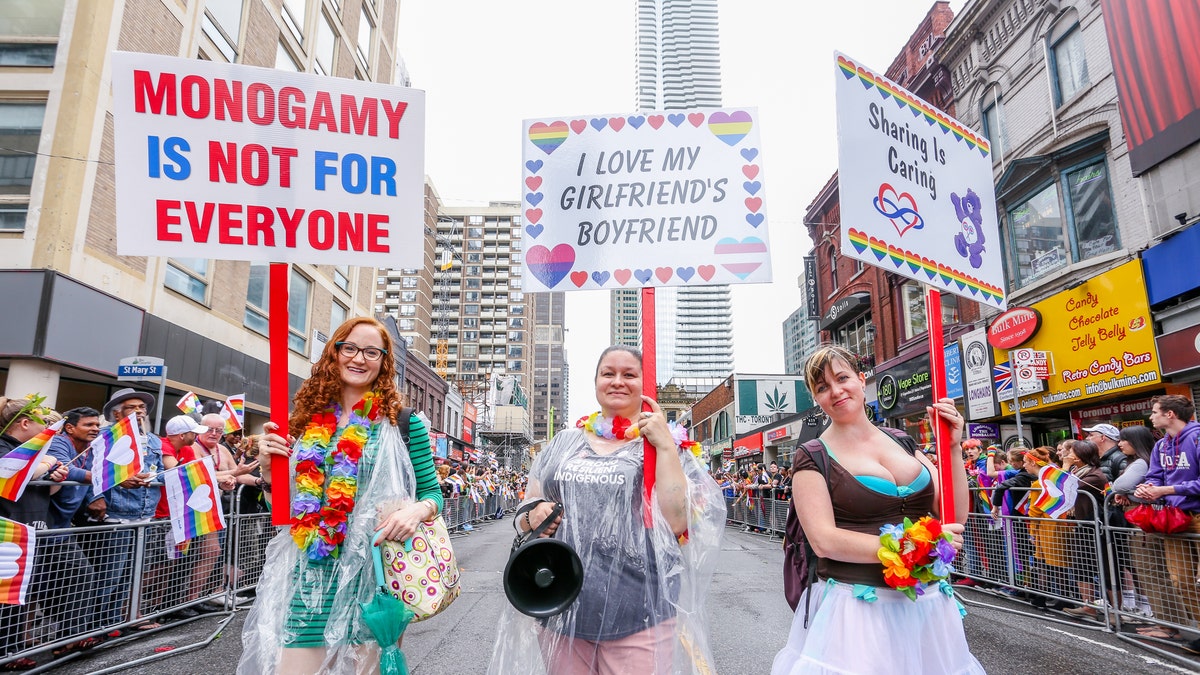 Pro-Polyamory group marching with signs