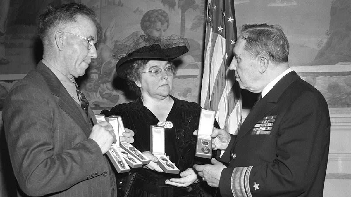 Man and woman receiving five purple hearts