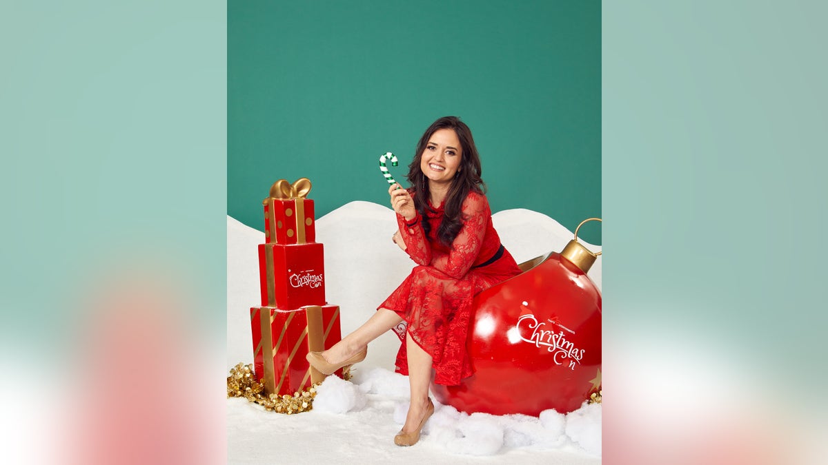 danica mckellar at christmas con holding candy cane